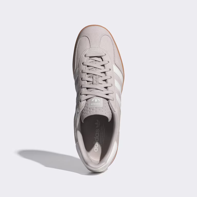 Neutral toned Veja Volley sneakers resting on linen