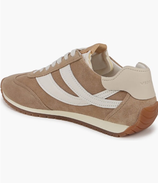 Quiet luxury sneaker styling with beige trousers