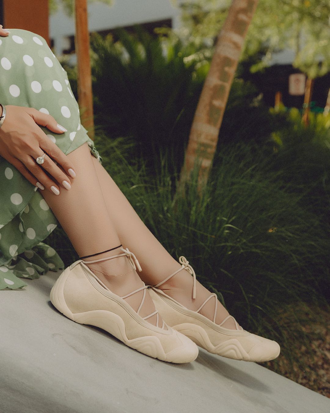 Woman wearing ballet sneakers with wide leg trousers